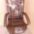 Black/Red revolving office chair with cushioned backrest and metal wheel base