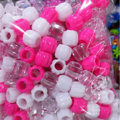 Multicolor plastic pony beads in pink white and transparent colors for jewellery making and DIY craft projects.