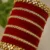 Red velvet bridal bangles set with 34 designer wedding chura bangles for women, traditional ethnic jewelry collection for bridal wear, wedding functions and festive occasions.