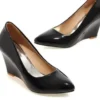 Women's black wedge heel pumps with glossy finish, slip-on design, closed pointed toe, comfortable wedge heel for office, party, wedding and casual wear.