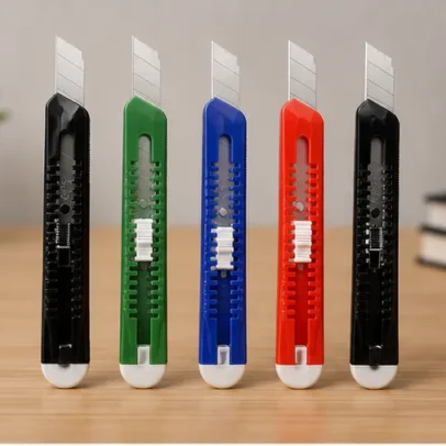 Heavy duty paper cutter knife with snap-off replaceable blade in assorted colours for cutting paper, cardboard, plastic sheets, packaging and craft materials.
