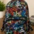 Kids multi-color printed backpack with graffiti design, spacious compartments, adjustable shoulder straps, lightweight school bag for boys and girls.