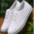 Kids white canvas school shoes with lightweight rubber sole, breathable fabric, lace-up design, comfortable everyday shoes for boys and girls aged 4–7 years.